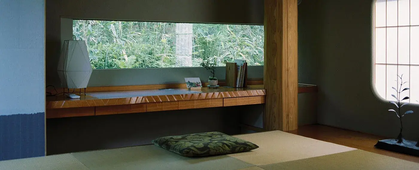 Tatami room with panoramic forest window and paper lantern at Togatta Onsen