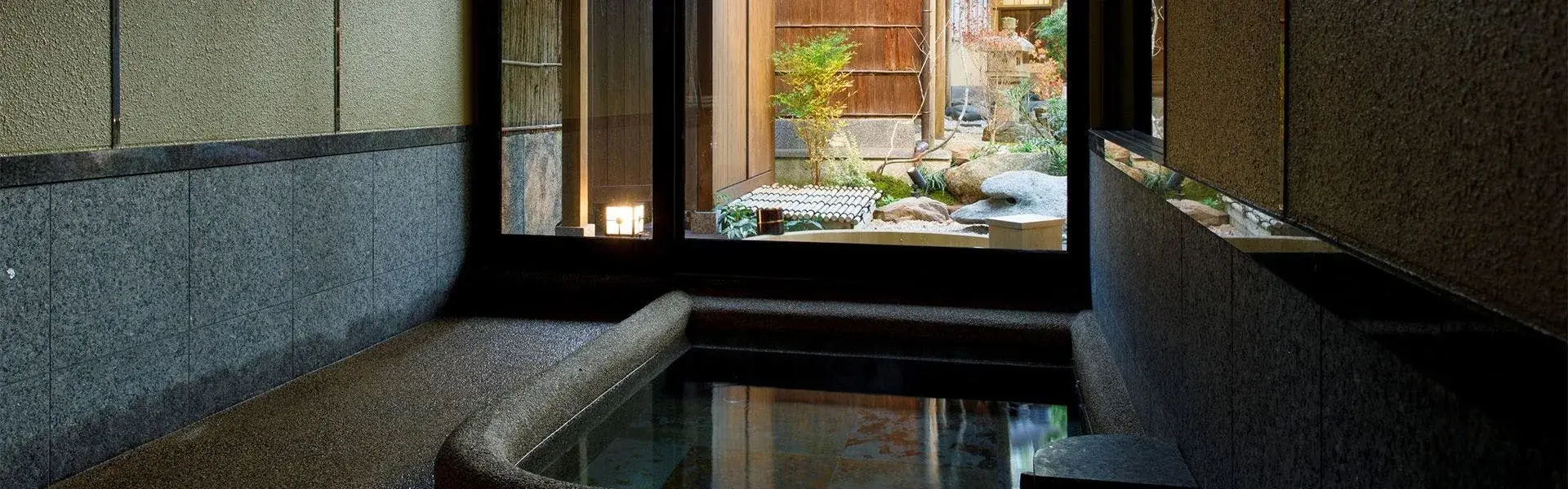 Private stone bath at Kokori-an Zuiun facing the candlelit courtyard garden