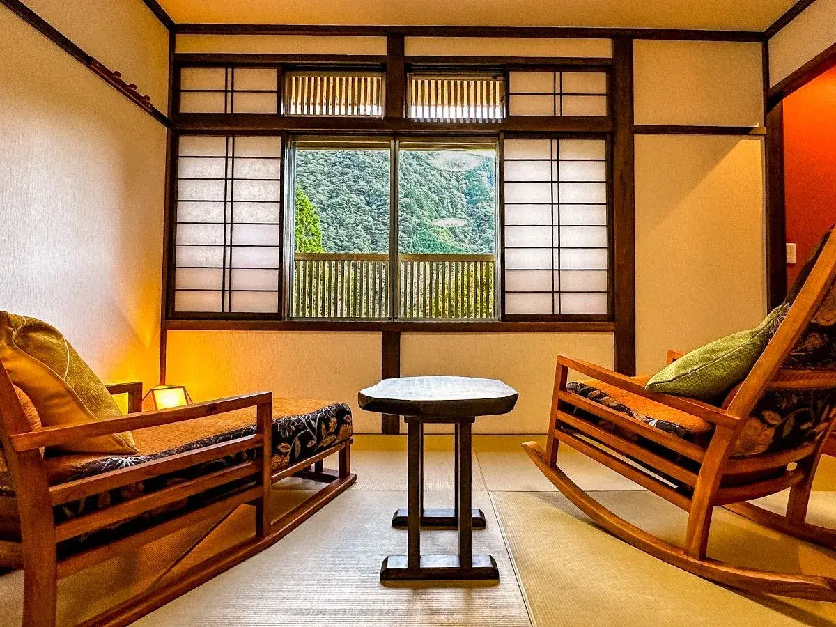 Tatami room with rocking chairs and shoji screens overlooking Umegashima cedar valley