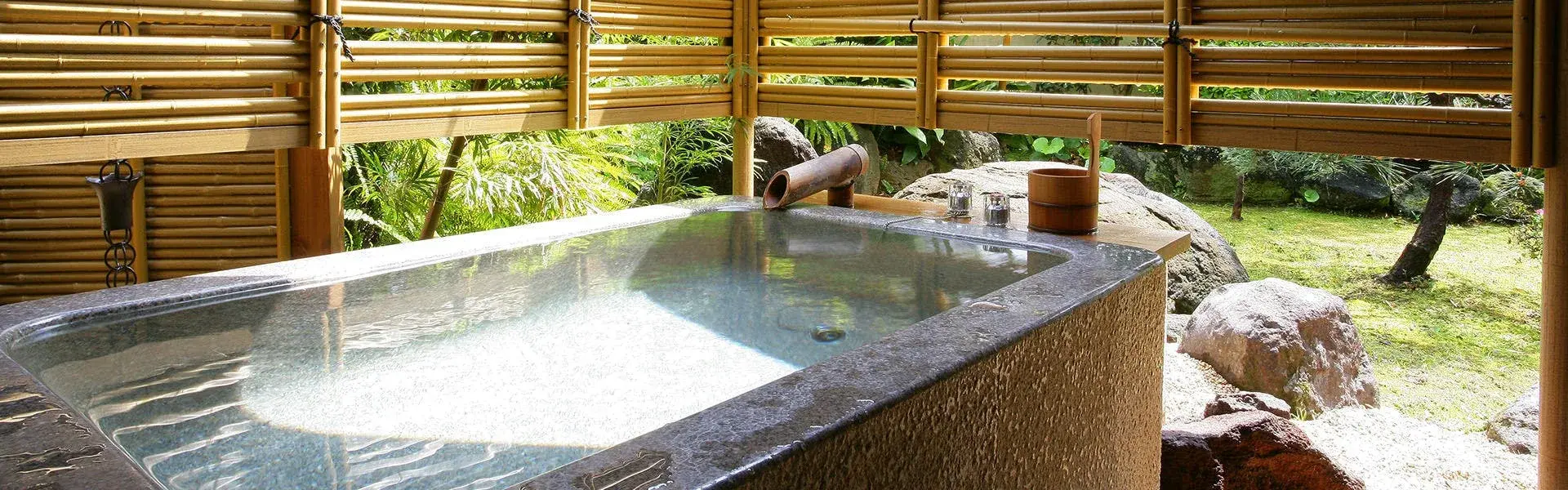 Private rotenburo with stone basin and bamboo screen at Furuya Ryokan in Atami