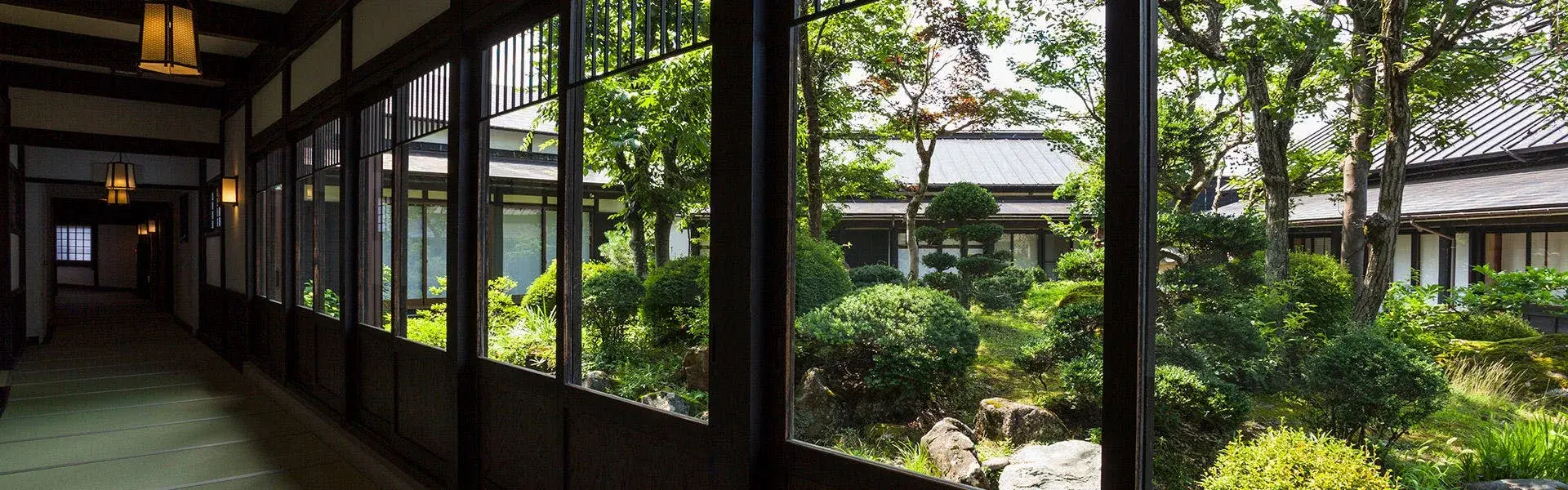 Covered gallery corridor facing ryugon's manicured Japanese garden in Minamiuonuma