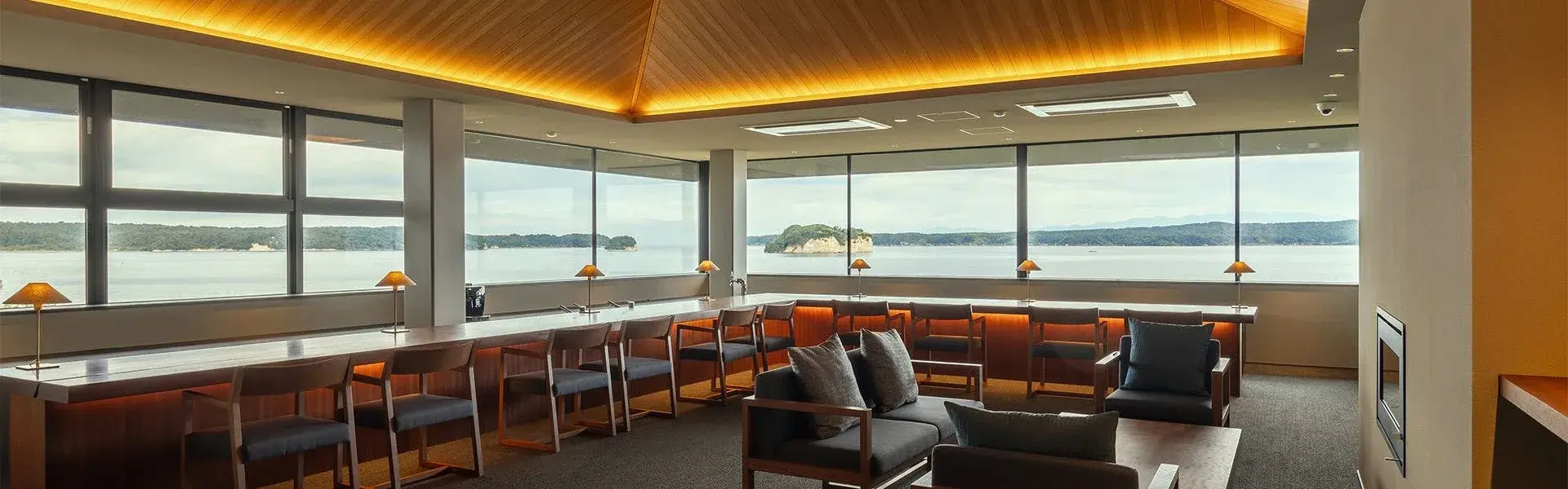 HITOTSU NOTOJIMA's bar lounge with panoramic views across Nanao Bay