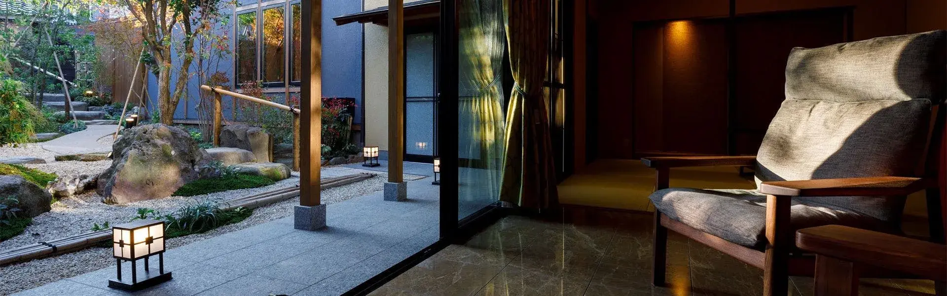 Zuiun's inner courtyard garden with stone lantern and bamboo fountain at dusk