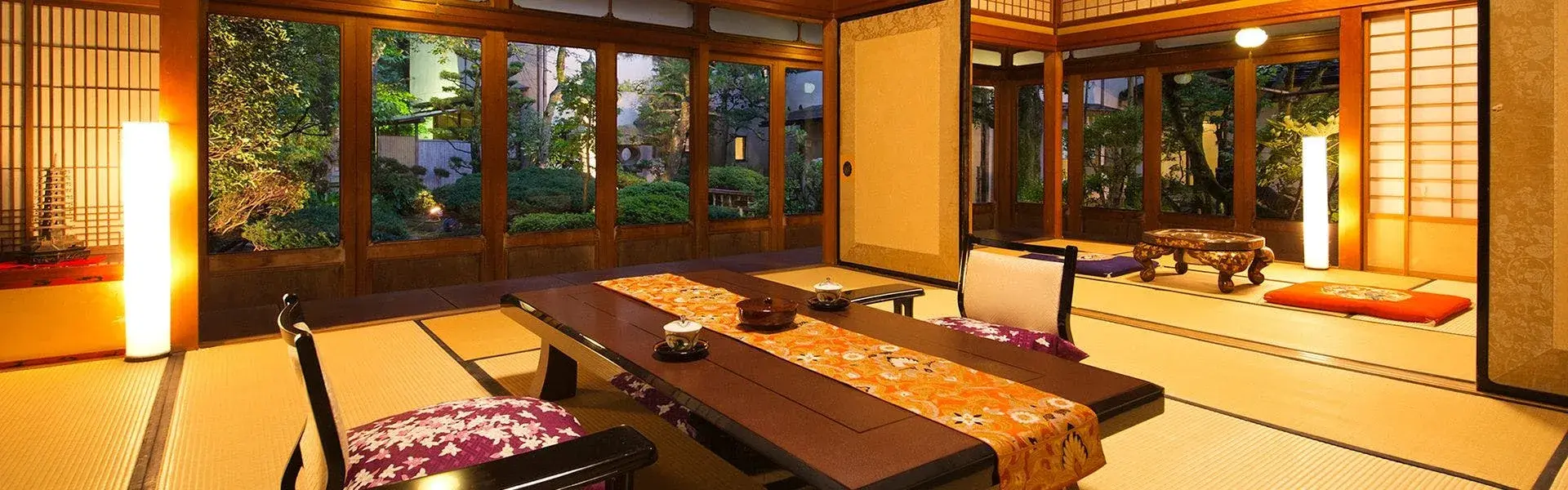 Tatami room with low dining table and shoji screens overlooking Kocho's inner garden