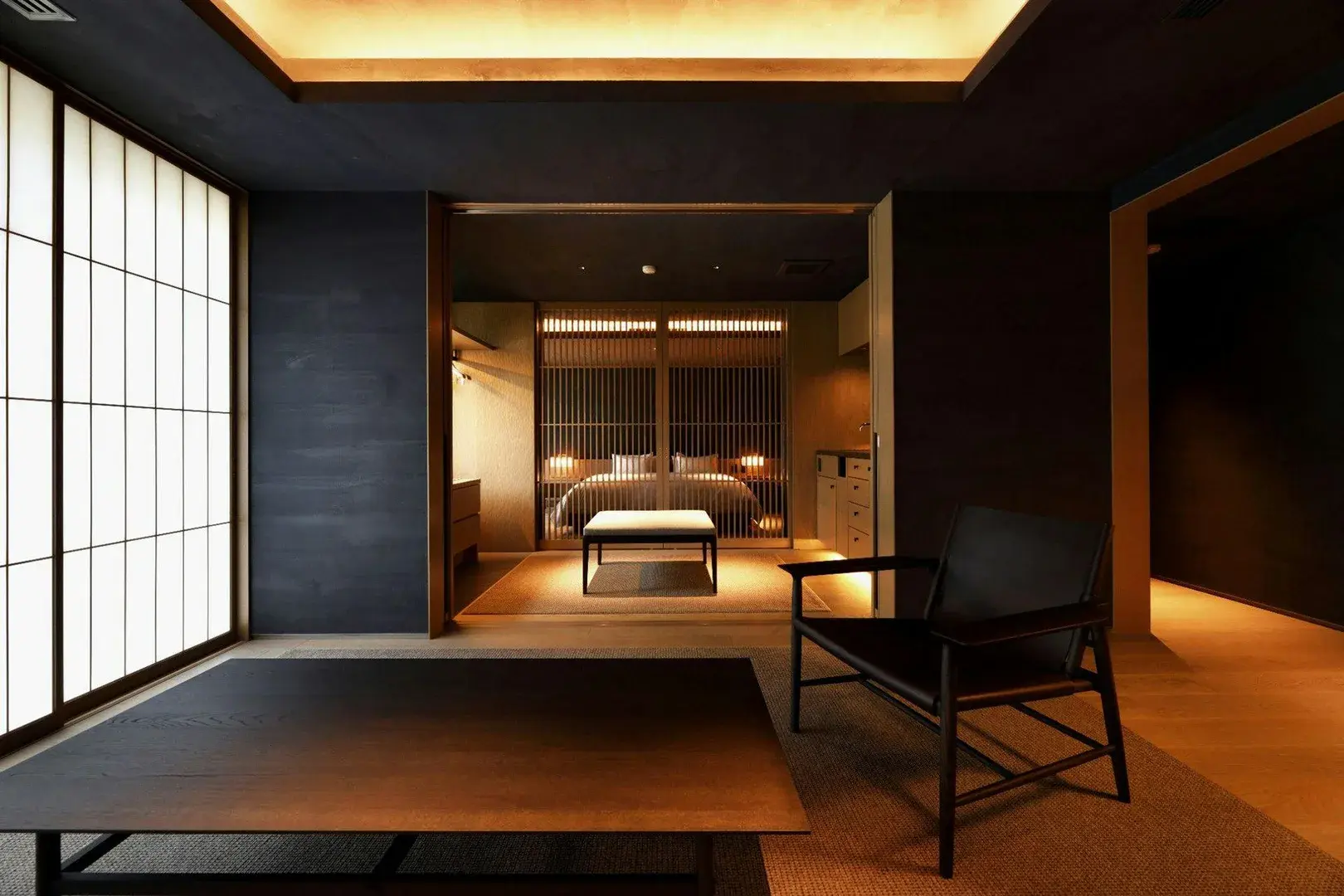 Tsuruko's tatami suite with dark plaster walls and shoji screen partition to bedroom