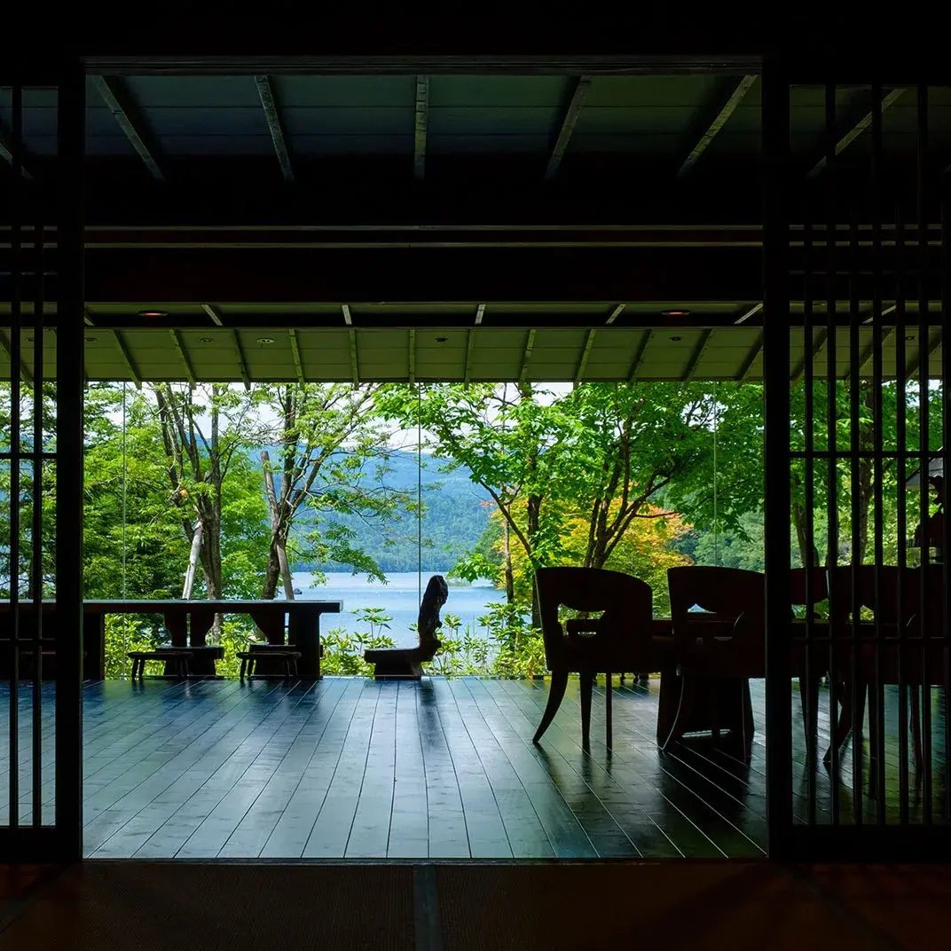 Open veranda at Akan Tsuruga Bessou Hinanoza frames Lake Akan through summer forest