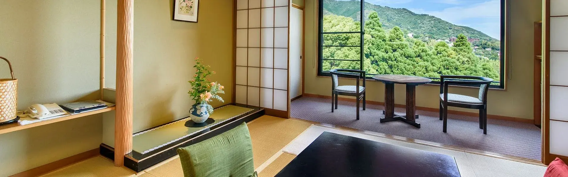 Tatami suite at Oyado Zuigetsu with shoji screens and wooded Yugawara hillside view