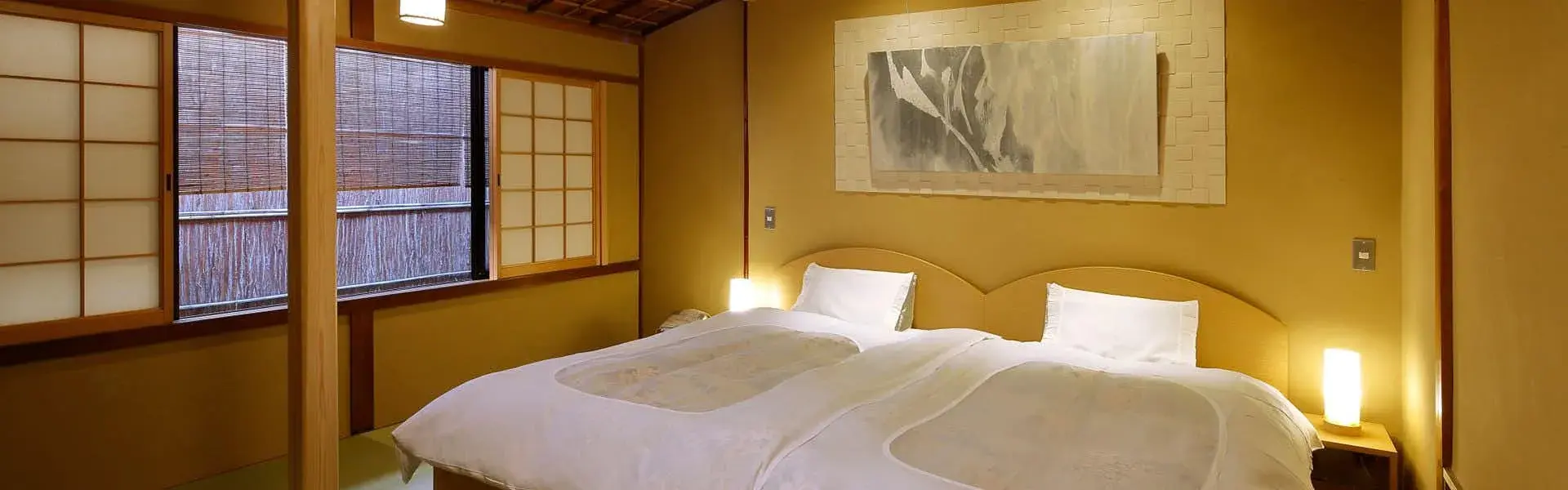 Twin bedroom at Sumiya with amber plaster walls and shoji screens in Nakagyo, Kyoto