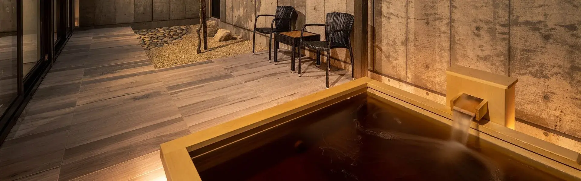 Private in-room hinoki onsen bath filled with dark Tokachigawa mineral water