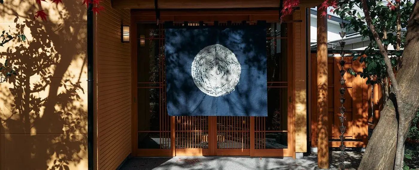 Indigo noren with moon motif at the entrance of Oyado Hiyama, Kinugawa Onsen
