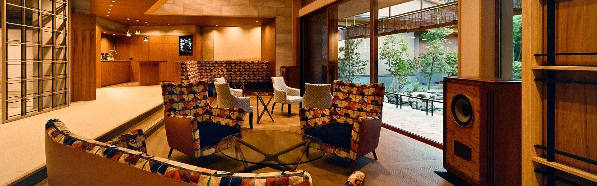 Beniya's lobby lounge with patterned armchairs and bamboo garden beyond