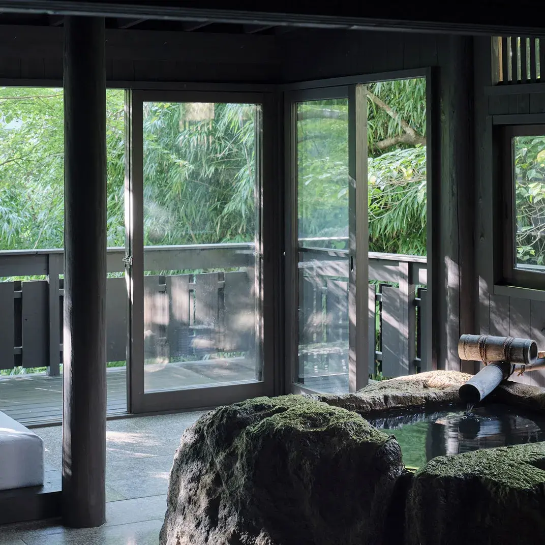 Private indoor bath with mossy rock surround and bamboo spout, Myoken Onsen