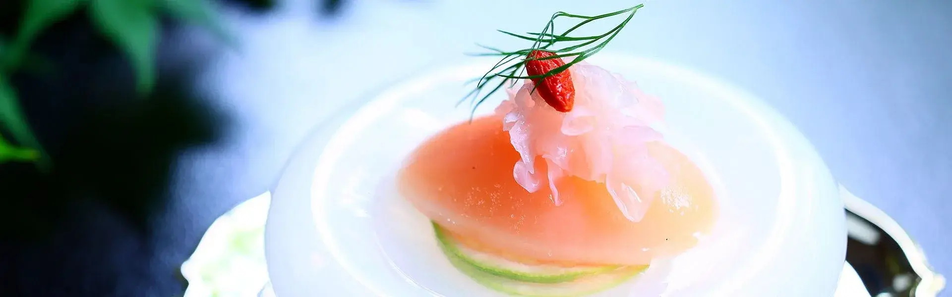 Chilled seasonal course with pink fruit, shredded daikon, and goji berry at Tsutsuji-tei