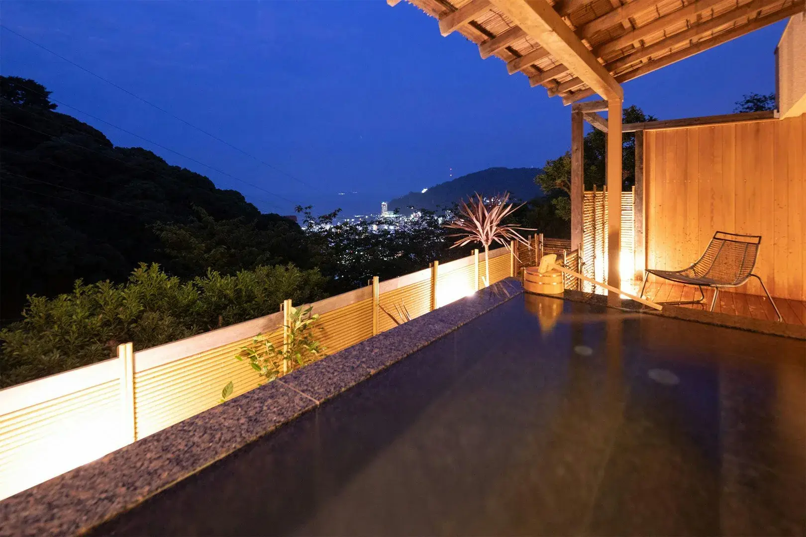 Private rotenburo at WA Tei Kazekomichi overlooking Atami city lights at night
