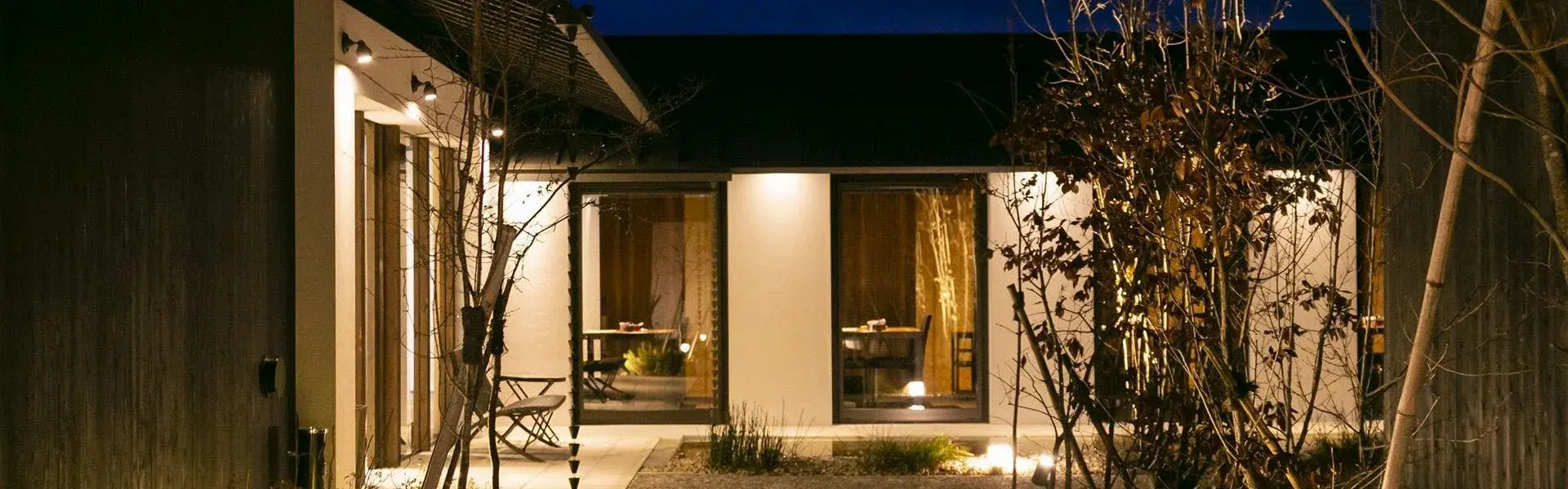 Yufuin Rokka cottage lit from within on a still Kyushu night