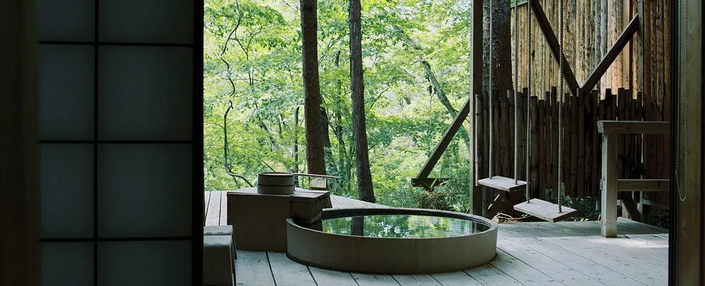 Private stone tub on a cedar deck opening to Zao forest at Daikon no Hana
