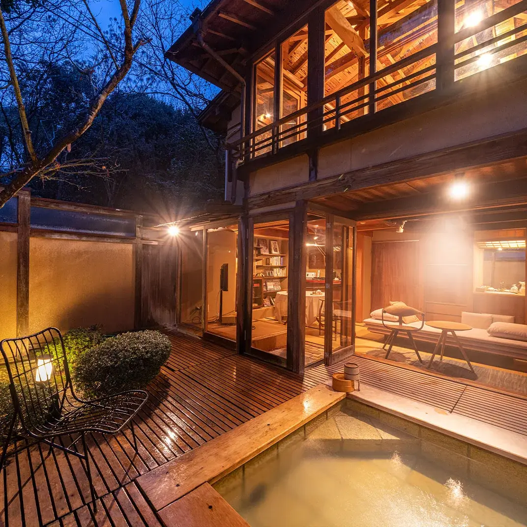 Private villa rotenburo on wooden deck at blue hour, Miyahama Onsen