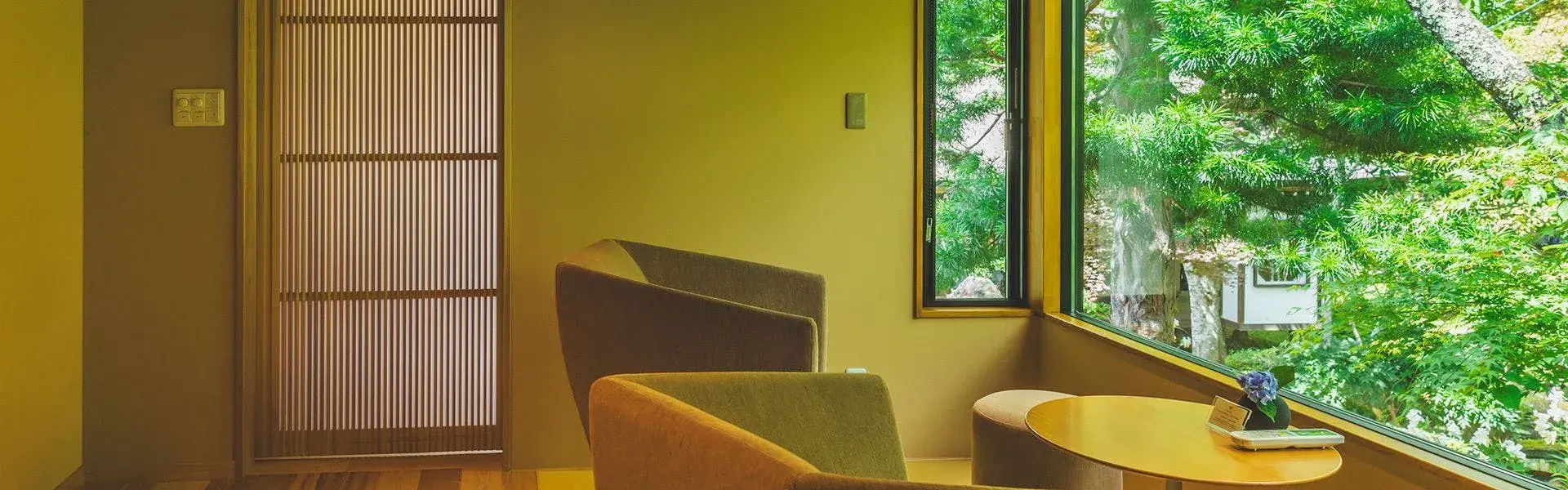 Sitting area with woven-screen door and Togakushi cedar forest at Fukujyuin Takei Ryokan