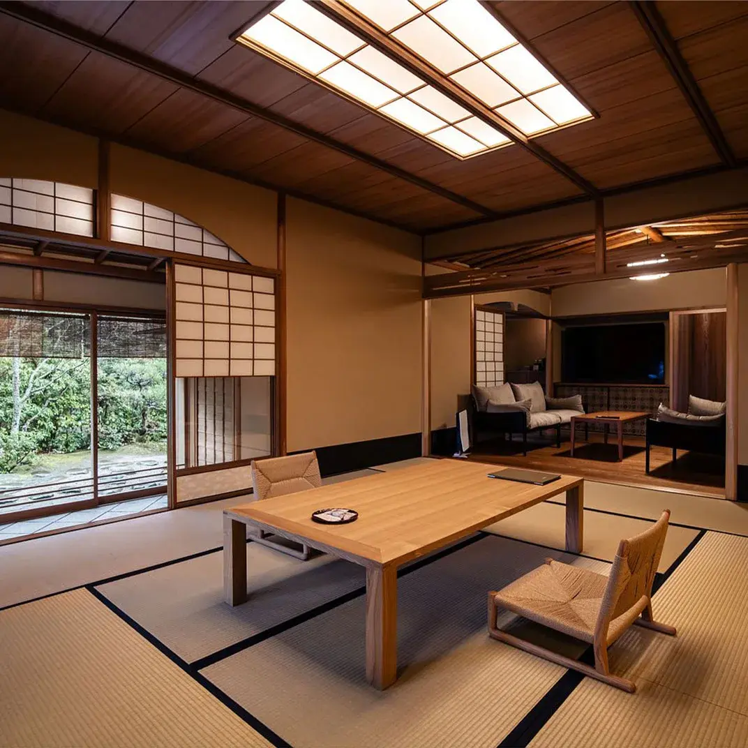 Monjusou Shourotei tatami room with low oak table and shoji screens overlooking a garden