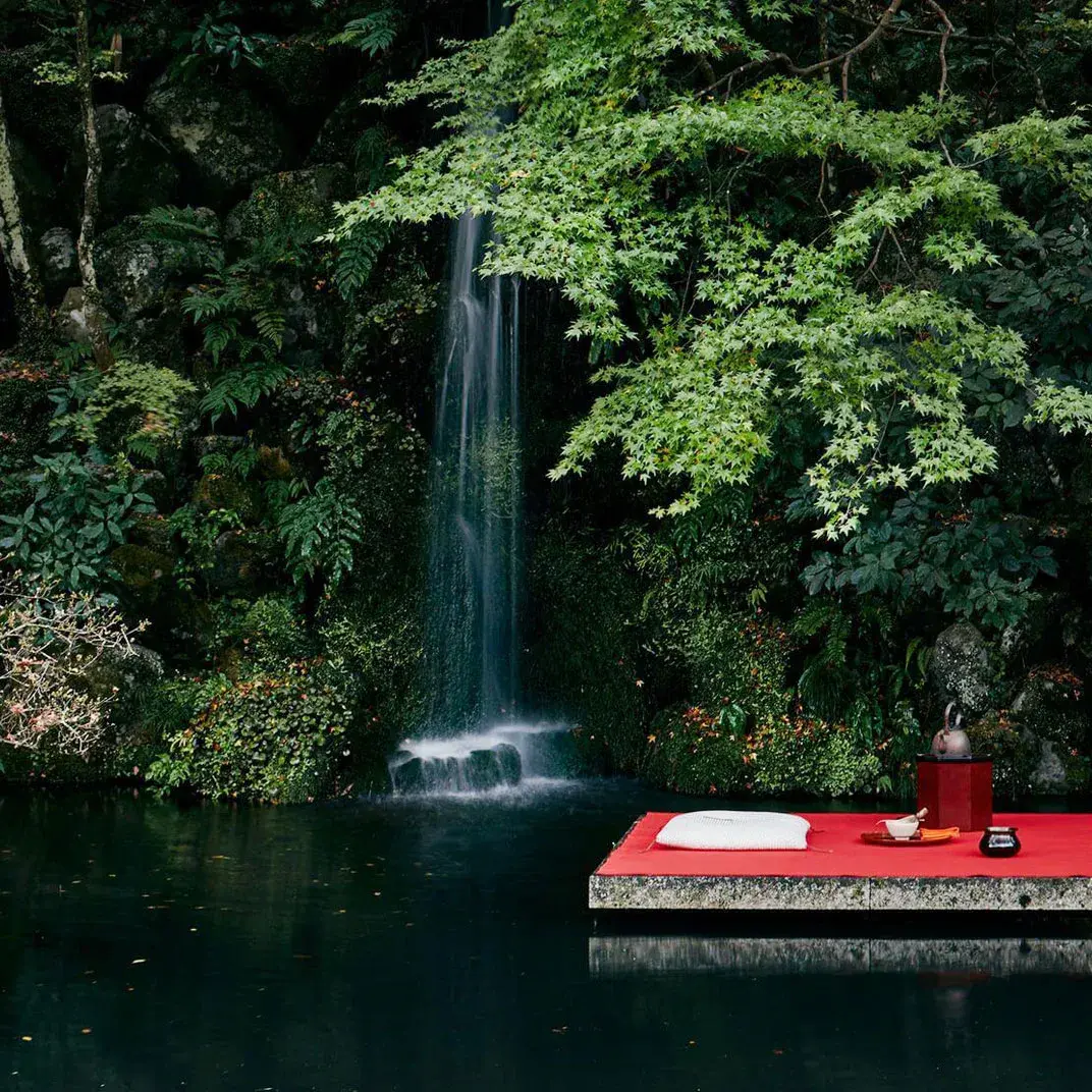 Stone meditation platform and waterfall in Hoshinoya Kyoto's private garden
