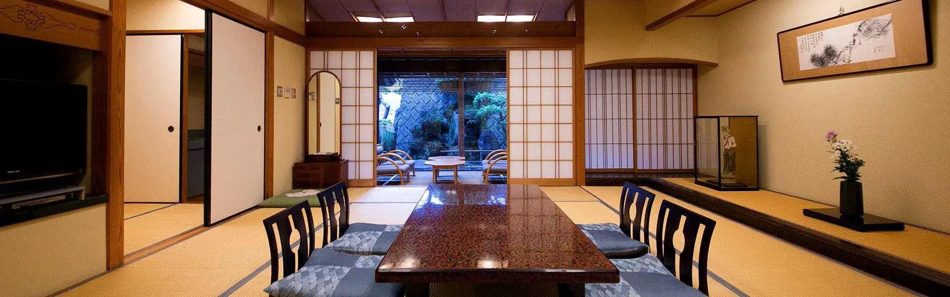 Furuya Ryokan tatami room with lacquered dining table and shoji garden view