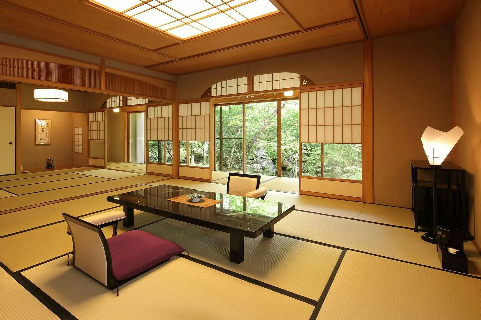 Spacious tatami room with lacquer table and garden shoji at Unzen Hanzuiryo