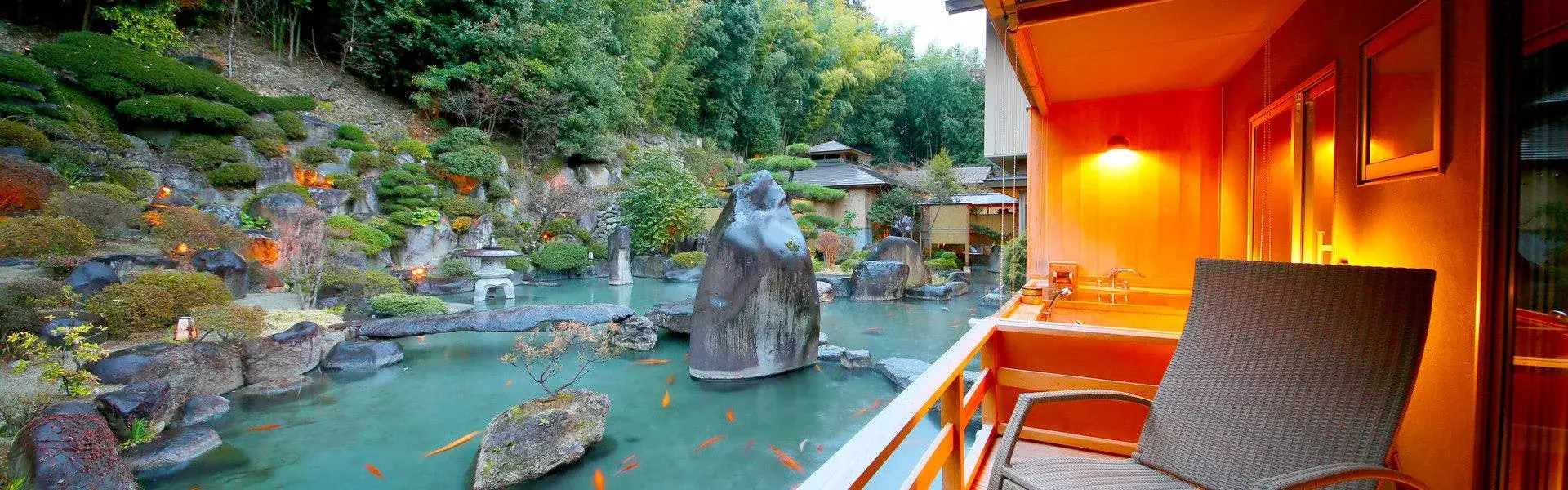 Zabou's stone-lantern koi pond and hillside garden seen from a room balcony in Koshu