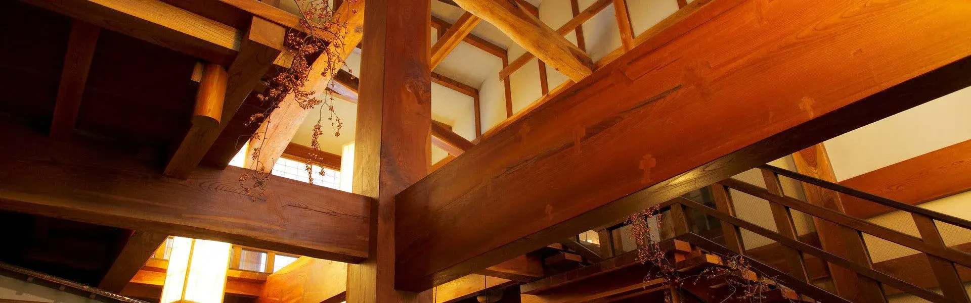 Soaring Hida cedar timber beams inside Hanaougi Bettei Iiyama's gassho-influenced atrium