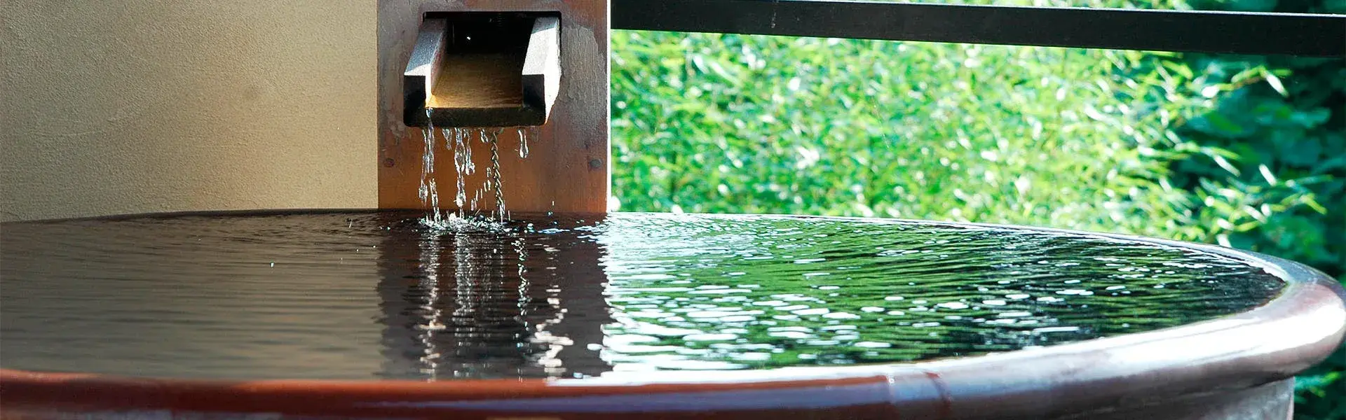 Private ceramic tub filling with Ito onsen water at Kawana Villa